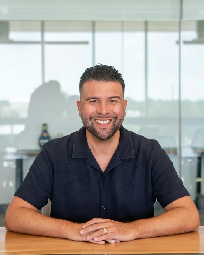 A business owner laughing at a meeting table